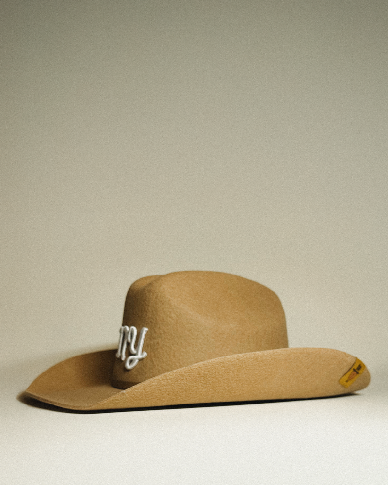 NY (New York) Teddy Headwear 100% wool Cowboy Hat, traditional Western cowboy hat silhouette for unisex in premium cream or brown wool colors with branded embossed metal hat band and silk interior lining.
