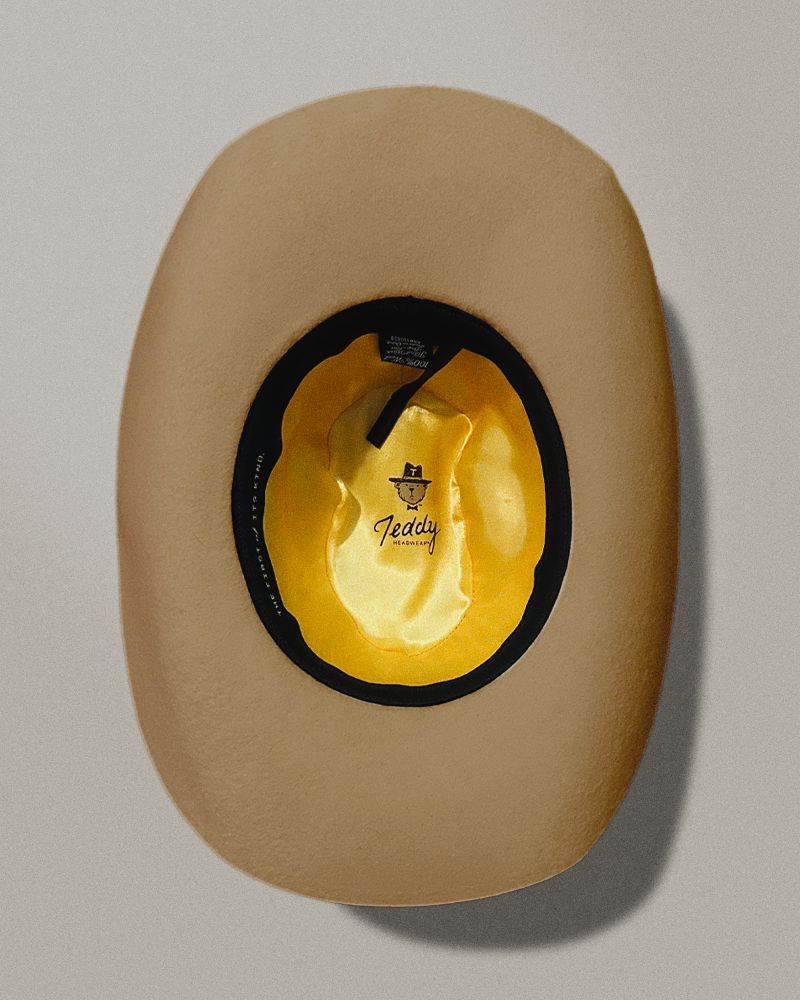 Teddy Headwear silk lining interior and adjustable sweatband with exterior hat band with debossed metal branding available in two colors, brown and cream, made for men and women.