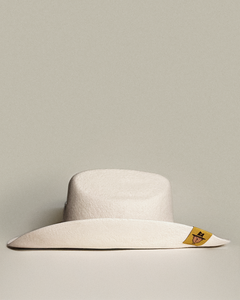 Teddy Headwear 100% wool Cowboy Hat, traditional Western cowboy hat silhouette for unisex in premium cream or brown wool colors with adjustable sweatband and exterior woven branded label.
