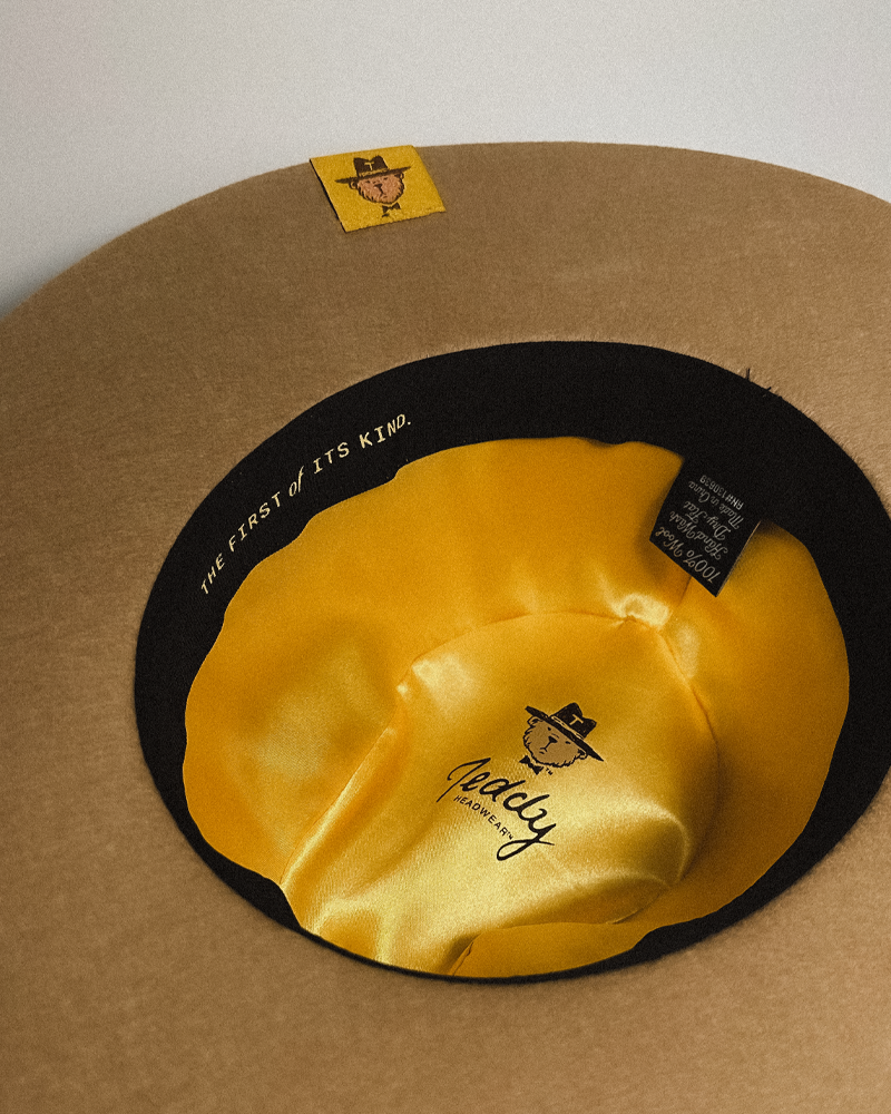 Teddy Headwear fully custom Texas Monogram Fedora hat with silk lining and adjustable sweatband and exterior hat band with debossed metal branding.