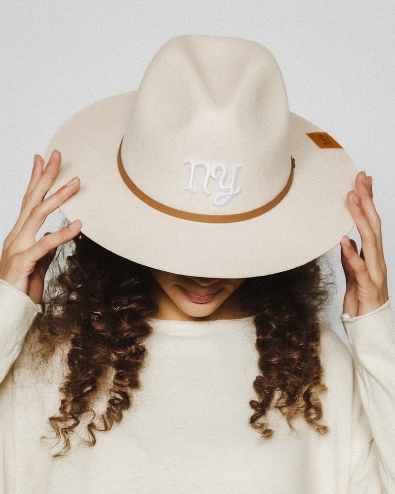 Woman Model wearing Teddy Monogram classic fedora in fashion studio with vintage aesthetic and contemporary design.