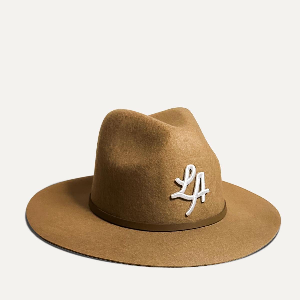 Classic fedora hat with structured crown and sleek finish, perfect for city style with embroidered original artwork. 