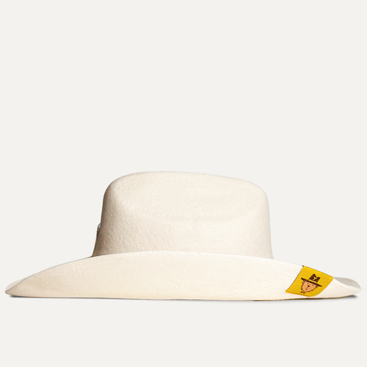 Teddy Headwear 100% wool Cowboy Hat, traditional Western cowboy hat silhouette for unisex in premium cream or brown wool colors with adjustable sweatband and exterior woven branded label.