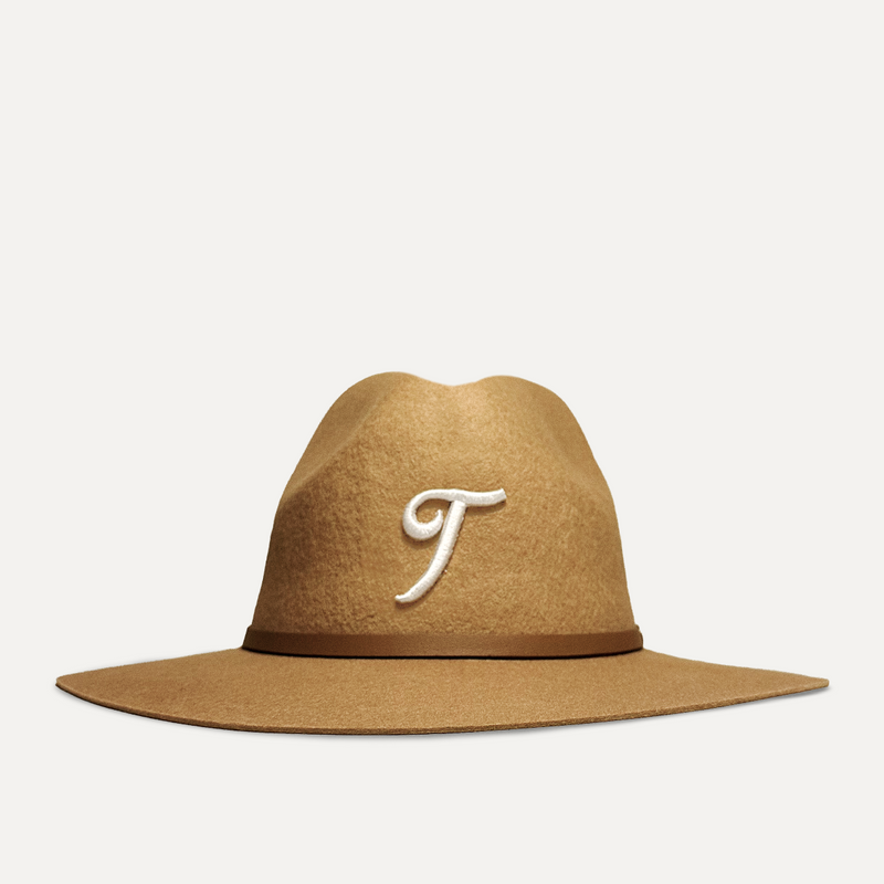 Teddy Headwear Texas Monogram Fedora, unisex wool fedora with wide brim, leather band, and embroidered T logo, available in cream and brown. 